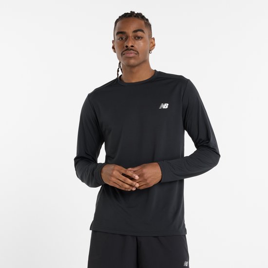 Man met vlechtjes draagt een zwarte longsleeve top van New Balance met een wit logo op de borst.