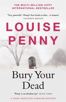 Boek "Bury Your Dead" van Louise Penny, met een grafsteen en bloemen in de sneeuw.