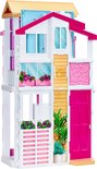 Roze en witte Barbie Malibu huis met 3 verdiepingen. De voorgevel heeft een roze deur, houten accenten en bloembakken.