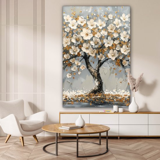 Canvas schilderij met een witte bloesem boom met gouden accenten in een woonkamer met een witte kast.