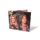 CD hoes met op de voorkant een foto van twee personen, een vrouw met lang blond haar en een man met lang bruin haar. De titel 'Renaissance Ashes Are Burning' staat bovenaan.