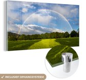 MuchoWow® Glasschilderij 80x40 cm - Schilderij acrylglas - Een dubbele regenboog boven een grasveld - Foto op glas - Schilderijen