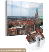 MuchoWow® Glasschilderij 80x60 cm - Schilderij acrylglas - Stadsgezicht van de Duitse stad Lübeck - Foto op glas - Schilderijen