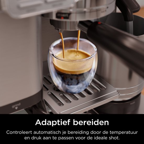Zilverkleurige Ninja koffiemachine die espresso zet in een glazen mok met dubbele wand.