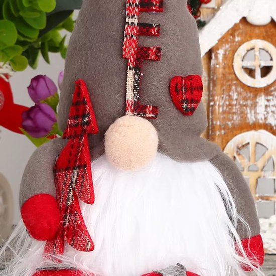 Gnome de Noël gris avec nœud rouge, barbe blanche, écharpe à carreaux et chaussures rouges.