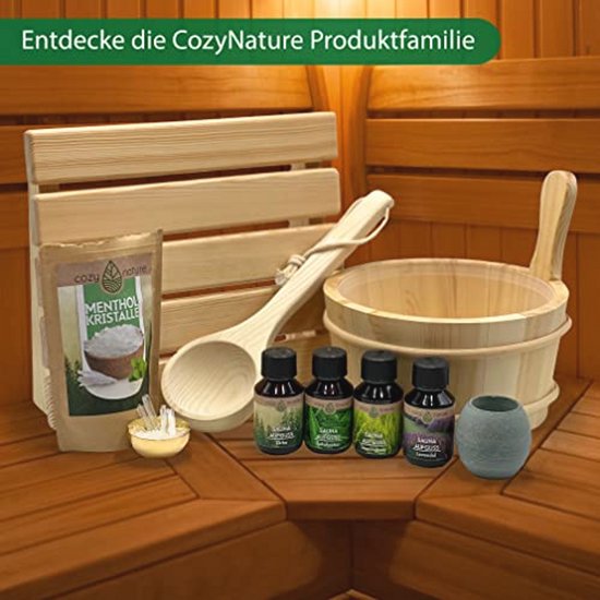 Garnituren voor de sauna, waaronder een houten emmer, schep, flesjes olie, menthol kristallen en een brillenhouder.