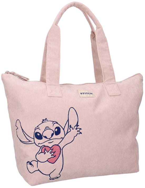 Sac en velours côtelé rose pâle avec Stitch tenant un cœur. Étiquette 'STITCH' au-dessus de l'imprimé.