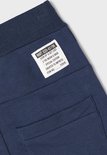 Label op donkerblauwe joggingbroek met tekst: NMT 028-65196 LOOK UP & GET LOST SPECIAL EDITION CREATED TO IMPRESS.