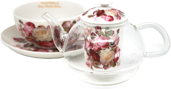 Queen Isabell kop en schotel met bloemmotief naast een glazen theepot met deksel en rozenpatroon.
