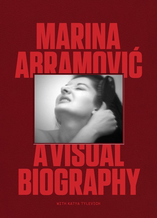 Boekhoes met rode tekst 'MARINA ABRAMOVIĆ A VISUAL BIOGRAPHY' en een z/w foto van Abramović die haar haar borstelt.