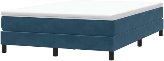 Donkerblauw boxspring bed met wit matras en matrasoplegger.
