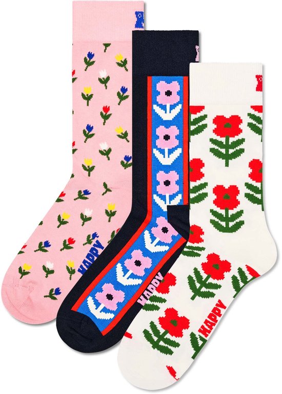 Drie paar Happy Socks met bloemenpatroon: roze met kleine bloemetjes, navy met een rand van bloemen, en wit met rode bloemen.