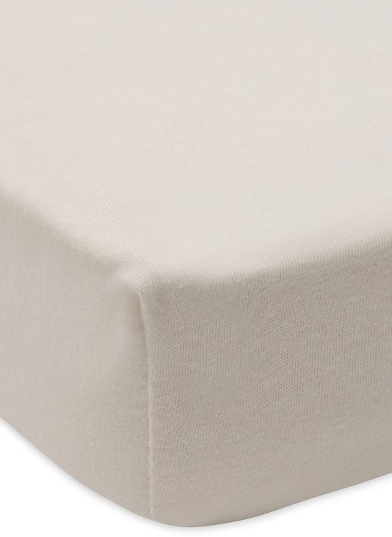 Detail van een beige jersey hoeslaken voor boxmatras met elastiek.