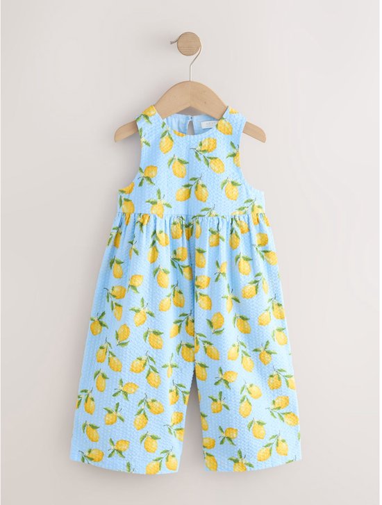 Lichtblauwe playsuit met all-over citroenprint en geborduurde textuur.