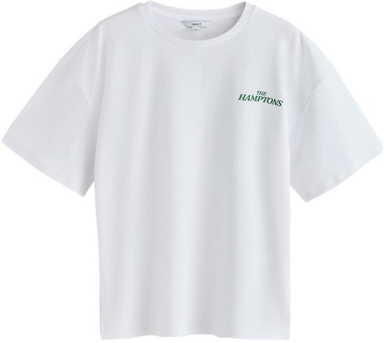 Wit oversized katoenen T-shirt met kleine groene tekst 'THE HAMPTONS' op de linkerborst.