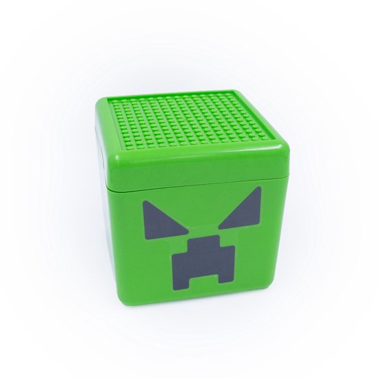 Dicht deksel van een groene creeper-opbergdoos met nopjes voor blokjes.