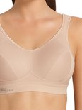 Close-up van een beige sportbeha met mesh panelen en "Anita ACTIVE" logo.