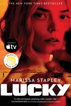 Couverture du livre 'Lucky' par Marissa Stapley, montrant un gros plan d'une femme et un arrière-plan avec une voiture en feu et un paysage désertique. "The New York Times Bestseller"
