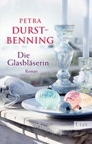 Boekcover met de titel "Die Glasbläserin" en decoratieve glazen kerstballen in pastelkleuren.