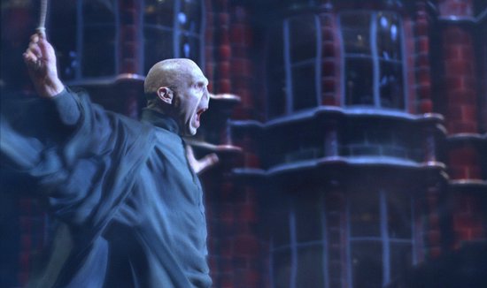 Voldemort schreeuwt, met een toverstok in zijn hand, in het donker.
