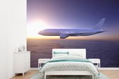 Behang - Fotobehang Een vliegtuig boven een wolkengordijn - Breedte 415 cm x hoogte 300 cm