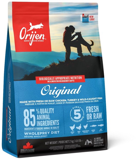 Orijen Original hondenvoerzak met afbeelding van persoon en hond in de bergen. Biologisch geschikt.