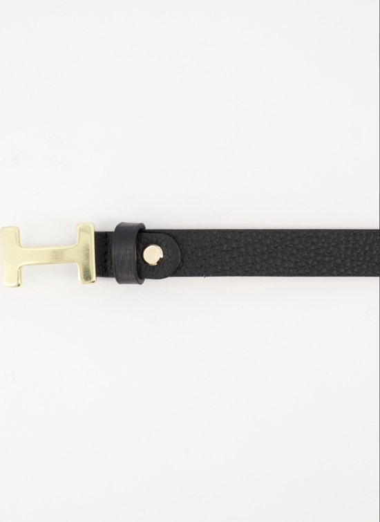 Close-up van een zwarte lederen riem met fijne korrel en gouden H-gesp.