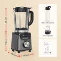 Grijze blender met afmetingen, glazen kan met fruit, 600ml drinkbeker, 250ml grinder en handleiding.