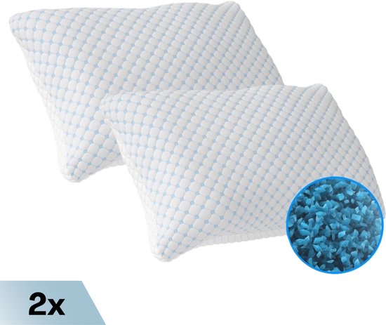 Twee witte kussens met een blauw honingraatpatroon, met vergrote weergave van blauw traagschuim.