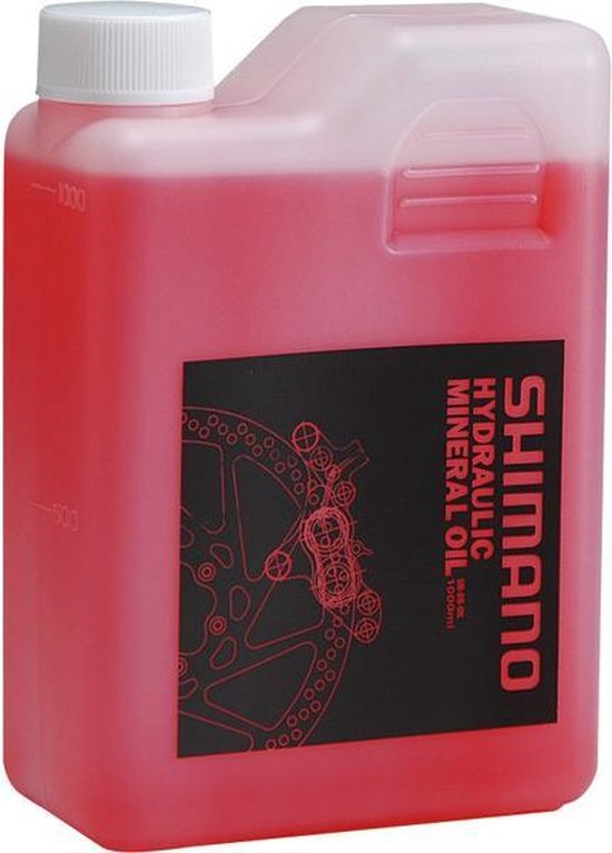 Fles Shimano hydraulische minerale olie met roze vloeistof. Zwart etiket met witte tekst "SHIMANO HYDRAULIC MINERAL OIL".