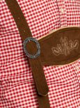 Gros plan de la culotte de leder brune avec motifs floraux brodés sur le devant et la boucle métallique de la bretelle.