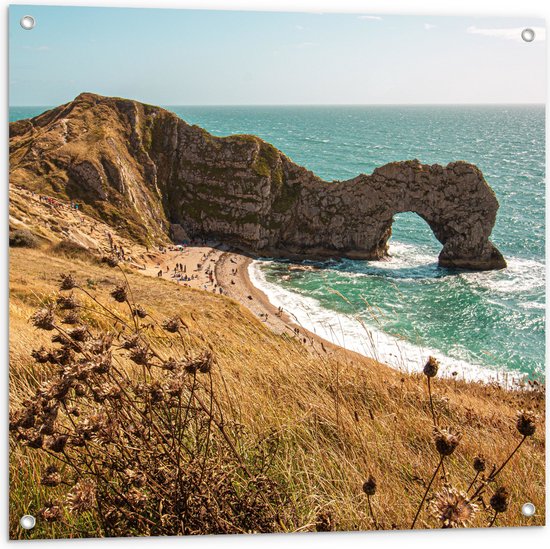WallClassics - Tuinposter – Zee met Grote Rots met Gat - 80x80 cm Foto op Tuinposter  (wanddecoratie voor buiten en binnen)