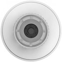 Bovenaanzicht van een witte radiatorthermostaat met een zwart middelpunt en grijze bevestiging.