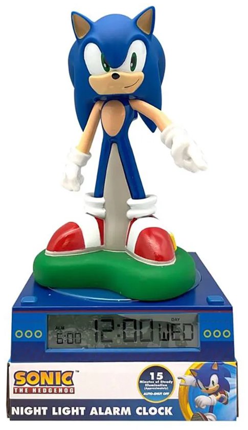 Blauwe Sonic the Hedgehog figuur op een blauw sokkel met groen gras. De klok toont 12:00 WED.