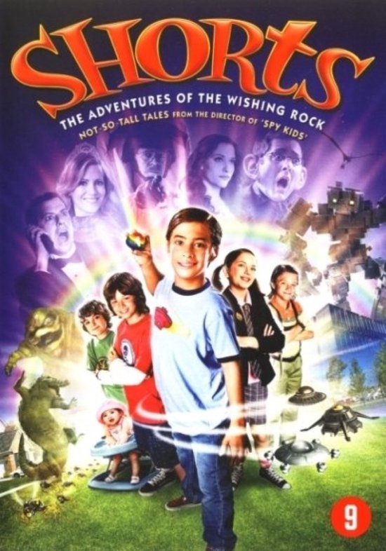 DVD-hoes voor de film 'Shorts'. Centraal staat een jongen met een regenboogkleurig object in zijn hand. Om hem heen diverse kinderen en volwassenen, met op de achtergrond buitenaardse wezens en een robot.