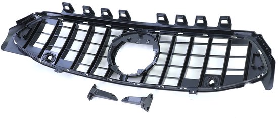 Glanzend zwarte grille met verticale spijlen, centrale cirkel en losse onderdelen.