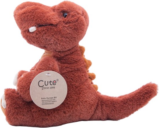 Zij-aanzicht van roodbruine dinosaurus knuffel met label 'Cute Since 1999'.