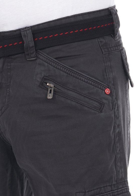 Detail van een donkergrijze cargobroek met schuine zak met ritssluiting en een rode knoop.