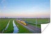 Poster Een trein rijdt door een landschap - 90x60 cm
