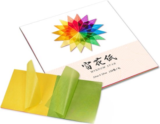 Een pak met gekleurd vliegerpapier met een twaalfpuntige regenboogster erop, met twee losse vellen geel en groen papier.