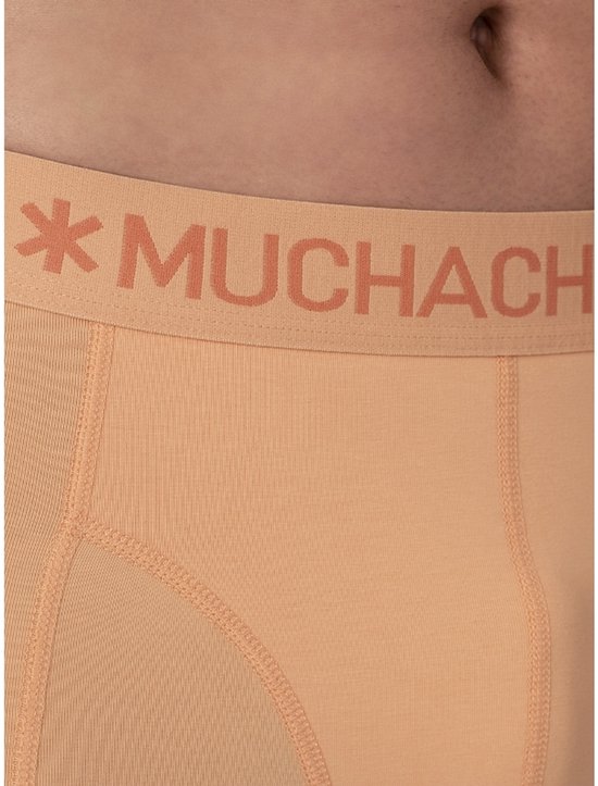 Detail van oranje Muchachomalo boxershort met logo op de tailleband.