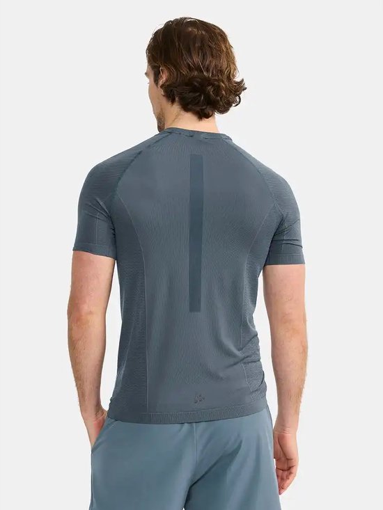 Grijze Craft sportshirt, achterkant met verticale lijn en een subtiel patroon op de mouwen.