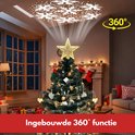 Gouden kerstboomster met 360° projectie van sneeuwvlokken op de kerstboom in een woonkamer.