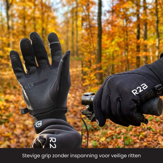 Twee zwarte R2B handschoenen in een bosrijke omgeving met herfstkleuren. De handpalm is zichtbaar met een anti-slip patroon.