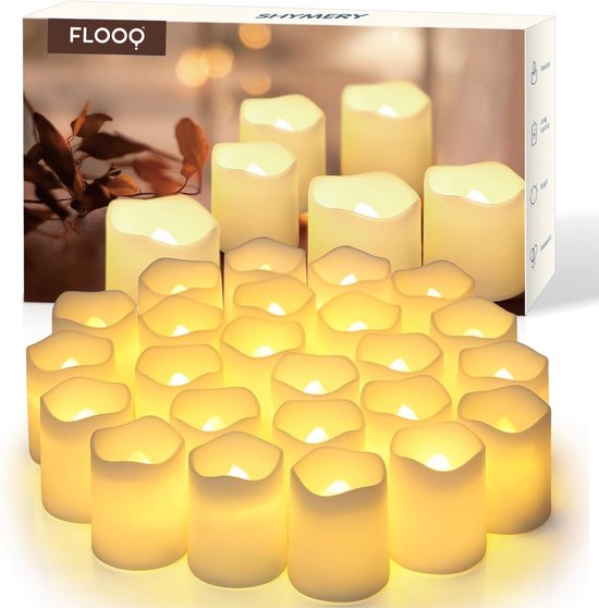 Doos met 24 witte LED-kaarsen, met de tekst 'FLOOQ SHYMER Y'. De kaarsen hebben warme, flakkerende vlammen.