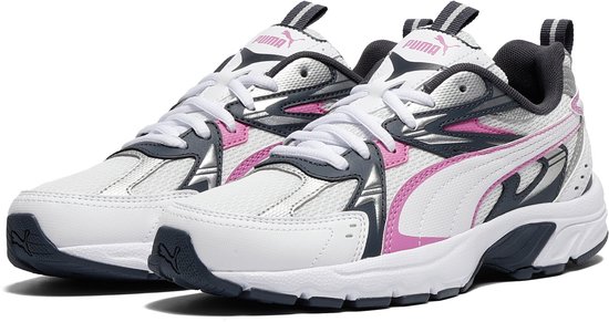 Een paar witte PUMA sneakers met roze en donkerblauwe details, op witte zolen.