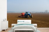 Behang - Fotobehang Tractor - Blauw - Mist - Breedte 420 cm x hoogte 280 cm
