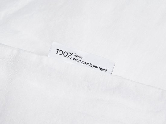 Label '100% linen produced in portugal' op wit linnen.