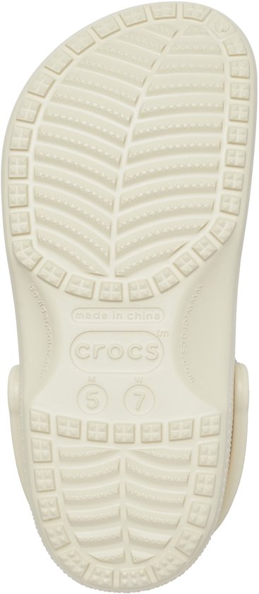Crème Crocs, de onderkant toont de textuur en het maat 7 (W) logo.