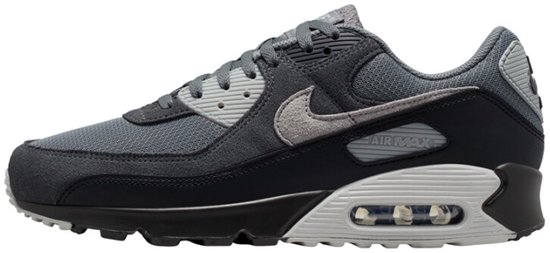 Baskets Nike Air Max 90 grises avec des touches de noir et de gris clair. La semelle présente une unité Air visible.